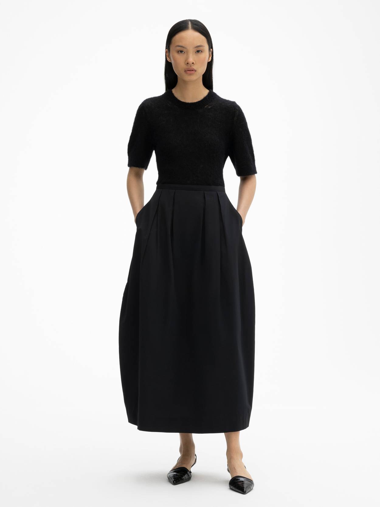 Curved pleated skirt